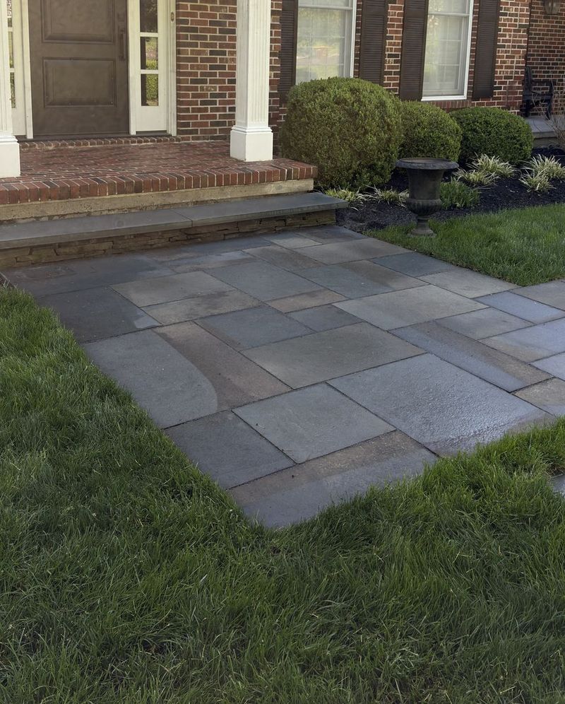 The same bluestone walkway after pressure washing, clean and even in color